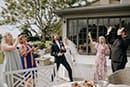 bride and groom with their guests drinking wine to celebrate their wedding- Hawke's Bay Wedding