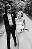 bride and groom walking and smiling in black and white blurry aesthetic shot- Hawke's Bay Wedding