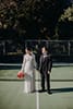 bride and groom standing in the tennis court- Waikanae Wedding