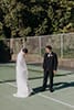 bride and groom admiring each other at the tennis court- Waikanae Wedding