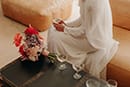 bride sitting with her beautiful bright florals- Waikanae Wedding