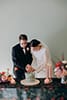 bride and groom slicing their wedding cake- Waikanae Wedding