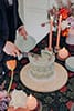 groom slicing their wedding cake with beautiful wedding detail- Waikanae Wedding