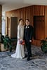 bride and groom standing outside their wedding venue- Waikanae Wedding