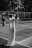 bride and groom playing tennis at the court- Waikanae Wedding