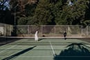 bride and groom playing tennis on their wedding- Waikanae Wedding