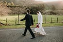 bride and groom walking in the middle of the road- Waikanae Wedding