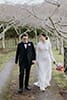 bride and groom beautifully walking in the middle of the road- Waikanae Wedding