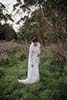 bride fixing her bridal dress in the middle of the forest- Waikanae Wedding