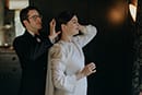 bride and groom helping each other get ready for their wedding ceremony- Waikanae Wedding