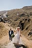 bride and groom walking in the high mountains- New Zealand Elopements