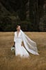 bride standing in the middle of the mountains as the cold breeze pass by her- New Zealand Elopements