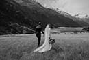 bride and groom walking in the mountains- New Zealand Elopements