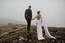 bride and groom in the middle of cloudy mountains- New Zealand Elopements