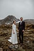 bride and groom in the middle of the mountains looking at the wonders of nature- New Zealand Elopements