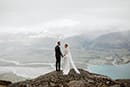 bride and groom in the middle of the cloudy mountains- New Zealand Elopements