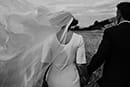 bride and groom walking as the cold breeze pass by them- New Zealand Elopements