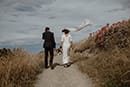 bride and groom walking while the cold wind pass by them- New Zealand Elopements