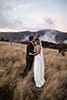 bride and groom lovingly in the moment in the middle of the mountains- New Zealand Elopements