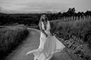 bride carrying her bridal dress as the cold breeze pass by her- New Zealand Elopements